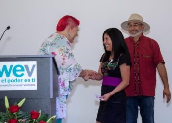 Silveria Ortiz German, of Silver Language Services, shakes hands with Juliana Ramirez at the ceremony.