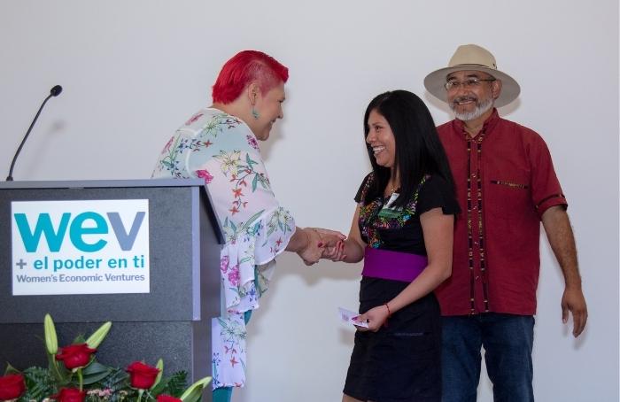 Silveria Ortiz German, of Silver Language Services, shakes hands with Juliana Ramirez at the ceremony.