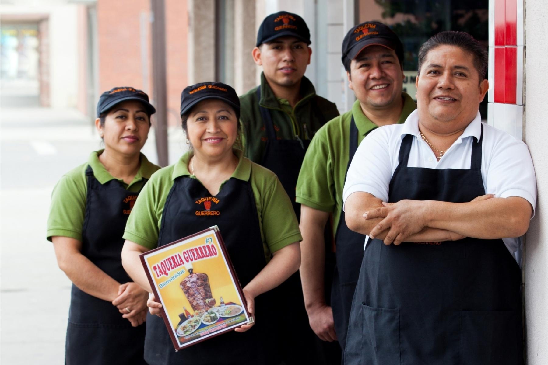 Gelacio Lopez with his employees outside his business, Taqueria Guerrero.