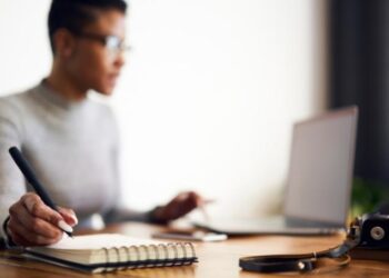 Entrepreneur working through checklist to prepare for launching a business