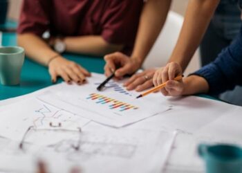 Business owner reviews key performance indicators on business dashboard with team