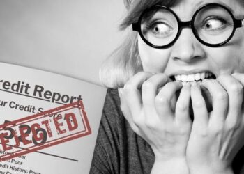 Woman sees credit report with a "Rejected" stamp and bites her nails in fear