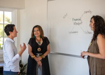 WEV staff, Irene Kelly discussing finances with WEV clients