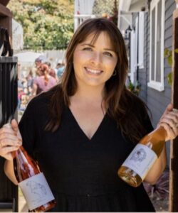 Natalie Albertson, holding wines from her business, Wildflower Winery